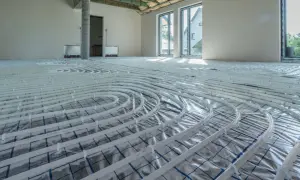 Instalacja ogrzewania podłogowego w nowym domu. Rozłożone rury zapowiadają komfort i niższy koszt ogrzewania.